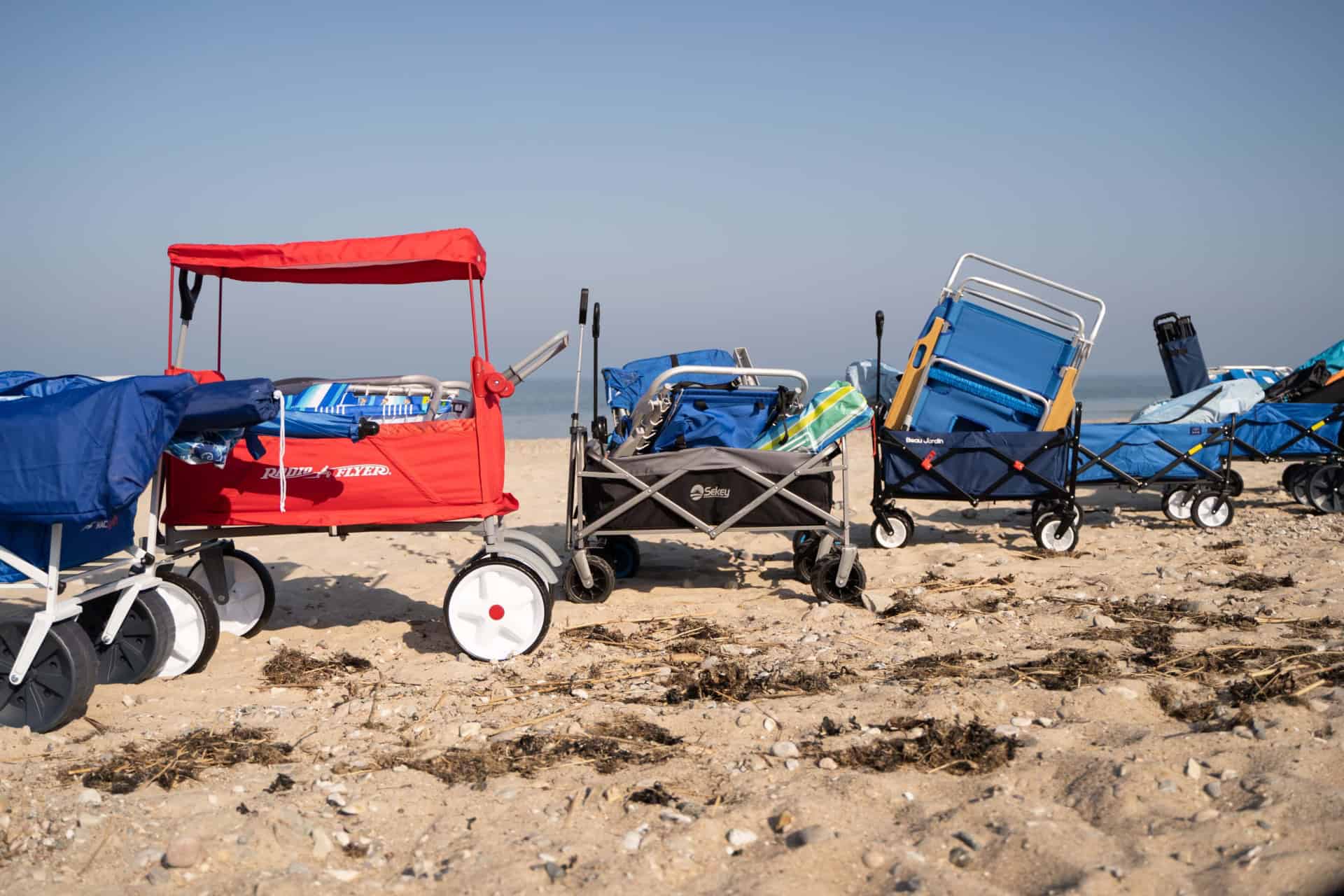 beach wagons on sand filled with beach gear