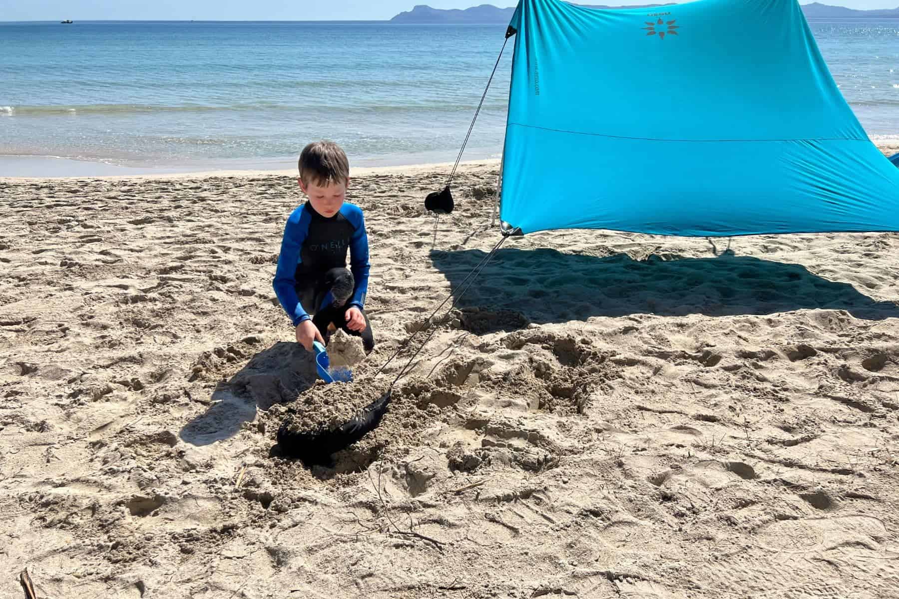 Neso Tents Beach Kid Shoveling On Beach