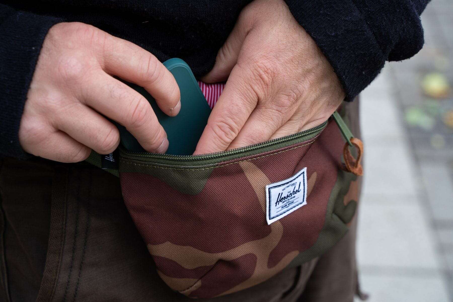 herschel-fourteen-belt-bag-close-up-reaching-compartment