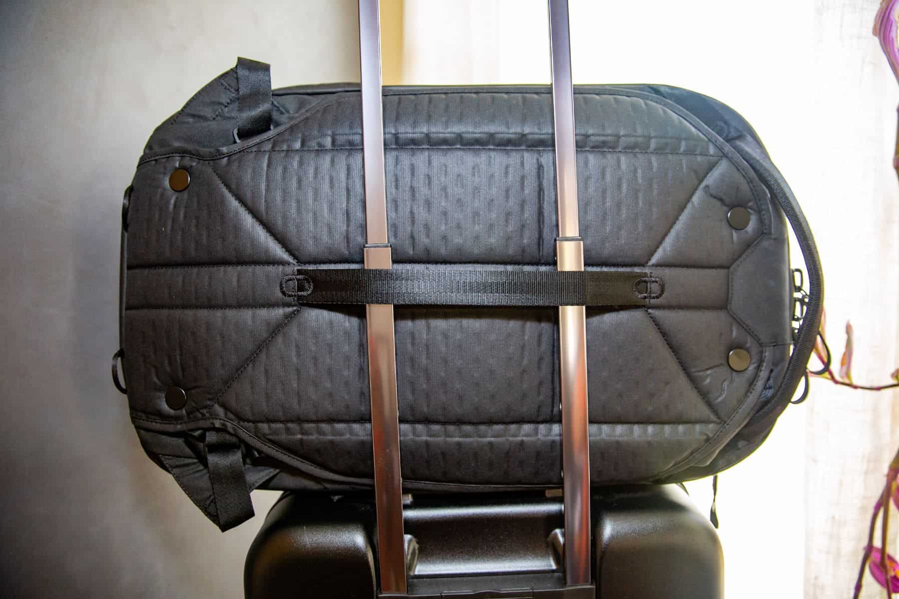 Stow the straps and give the bag a ride on your wheelie bag
