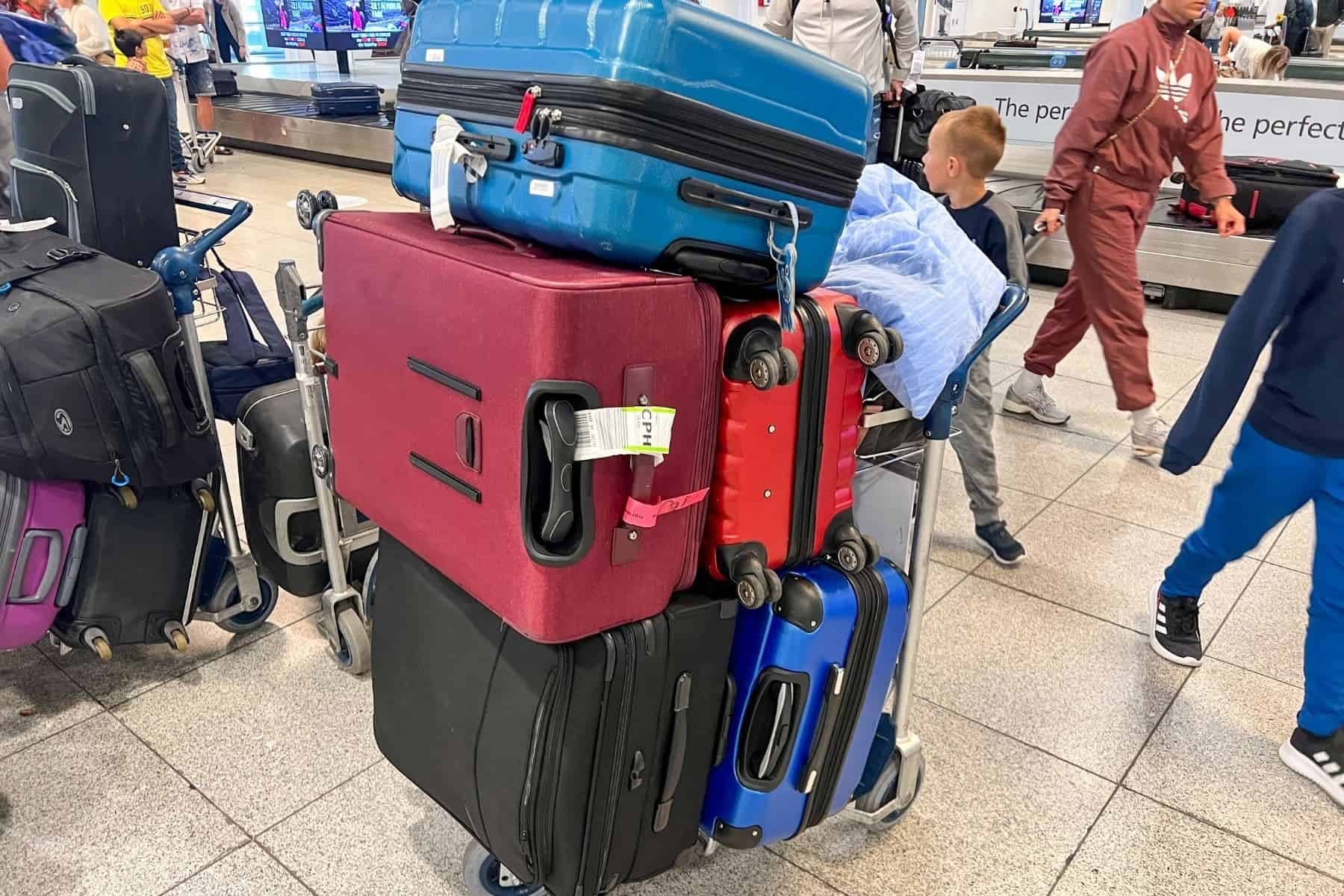 suitcases-and-travel-luggages-stacked-on-a-baggage-cart